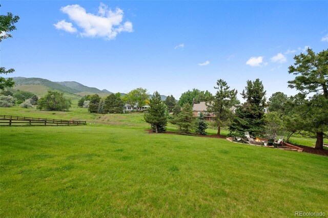 9 Red Fox Ln, Littleton, CO 80127 - view of yard featuring an outdoor fire pit and a mountain view