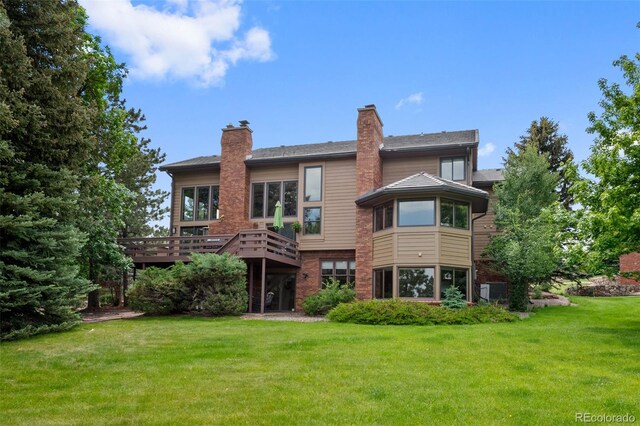 9 Red Fox Ln, Littleton, CO 80127 - back of property with a lawn, a deck, and a chimney