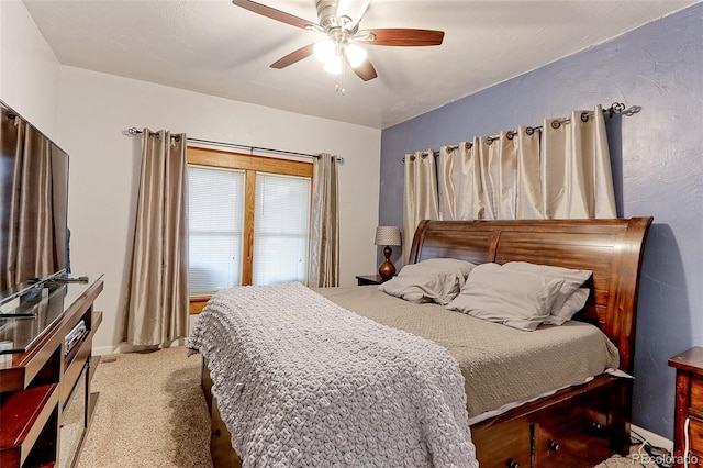 bedroom with ceiling fan and light colored carpet