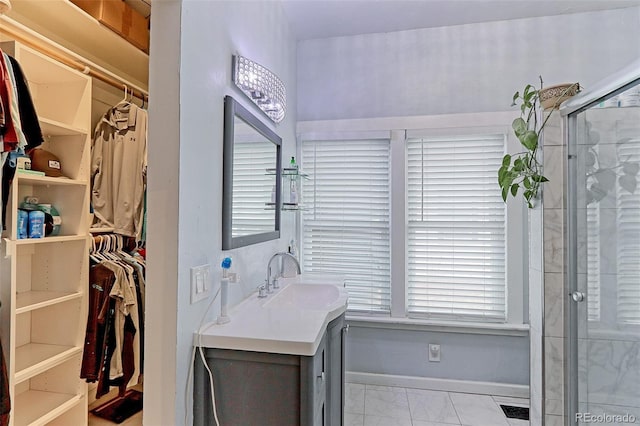 bathroom featuring vanity and a shower with door