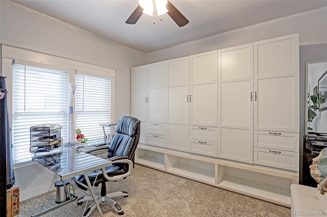 carpeted office space with ceiling fan