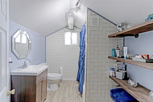 bathroom with walk in shower, toilet, vaulted ceiling, vanity, and hardwood / wood-style flooring