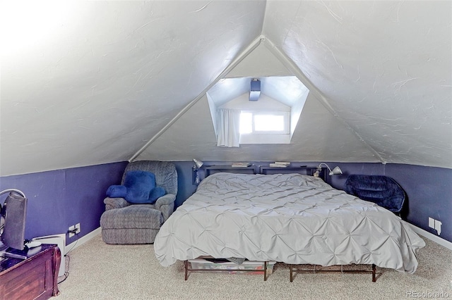 bedroom featuring carpet and lofted ceiling