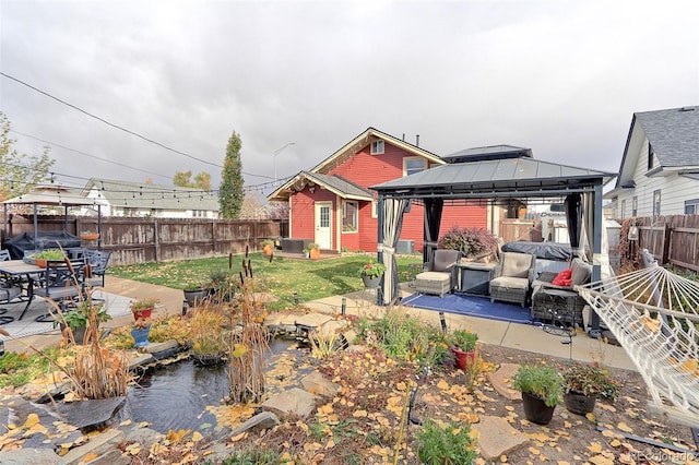 rear view of house with a gazebo and a patio area