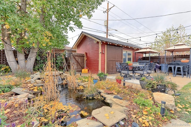 view of yard with an outdoor structure and a patio