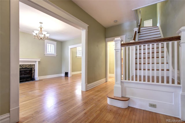 stairs featuring an inviting chandelier and hardwood / wood-style flooring