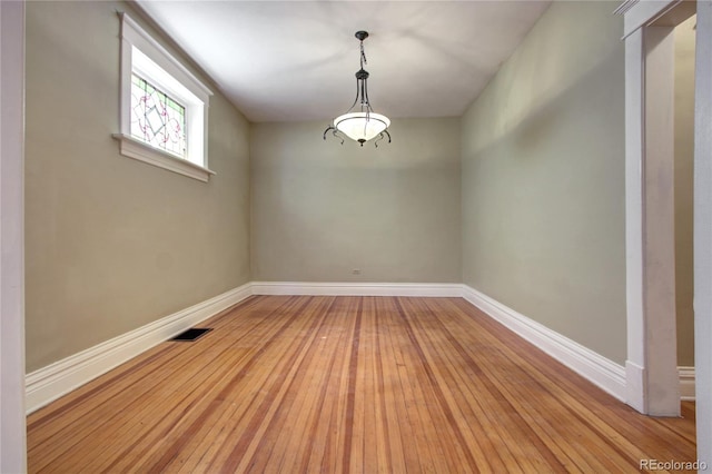 spare room with light hardwood / wood-style flooring