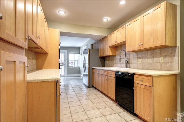 kitchen featuring light tile patterned flooring, sink, stainless steel refrigerator, dishwasher, and backsplash