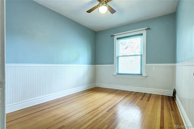 empty room with wood-type flooring and ceiling fan