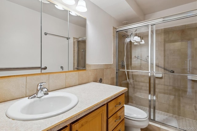 9340 E Center Ave Unit 1A, Denver, CO 80247 - bathroom with toilet, vanity, a stall shower, and tile walls