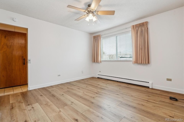 9340 E Center Ave Unit 1A, Denver, CO 80247 - empty room featuring a baseboard heating unit, hardwood / wood-style flooring, ceiling fan, and baseboards