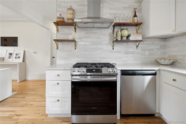 kitchen with stainless steel appliances, light countertops, open shelves, and extractor fan