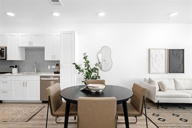 dining space featuring recessed lighting, visible vents, and light wood finished floors