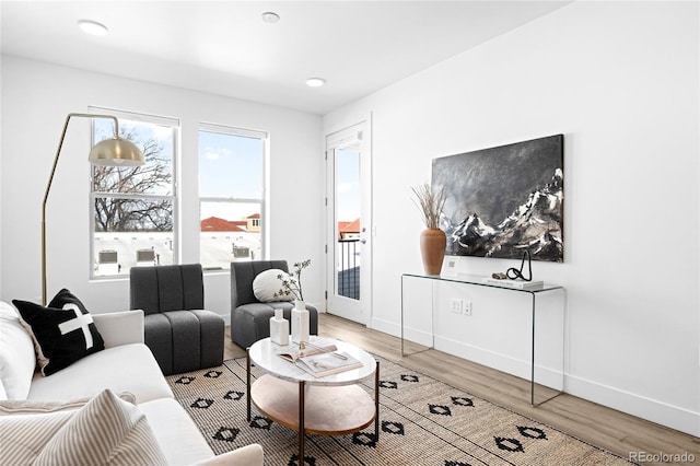 living room with light wood-type flooring and baseboards