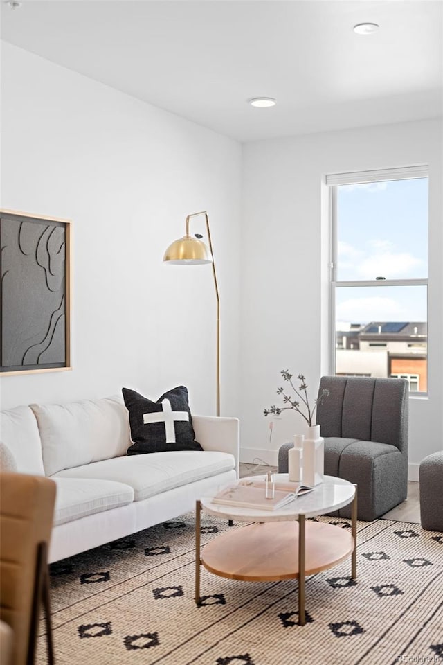 living area featuring recessed lighting, baseboards, and wood finished floors