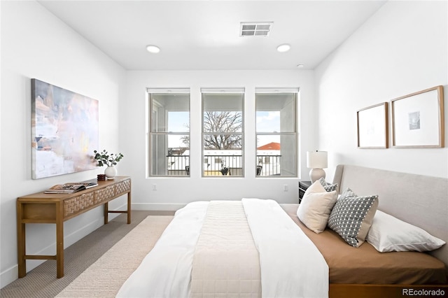 carpeted bedroom with recessed lighting, visible vents, and baseboards