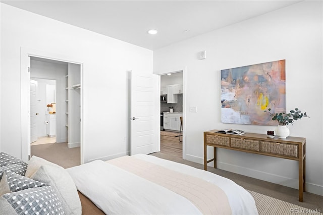 bedroom featuring recessed lighting, light colored carpet, and baseboards