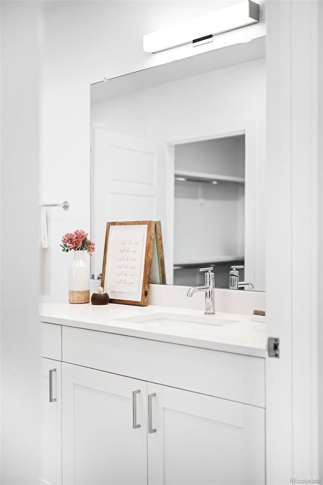 bathroom with a wall unit AC and vanity