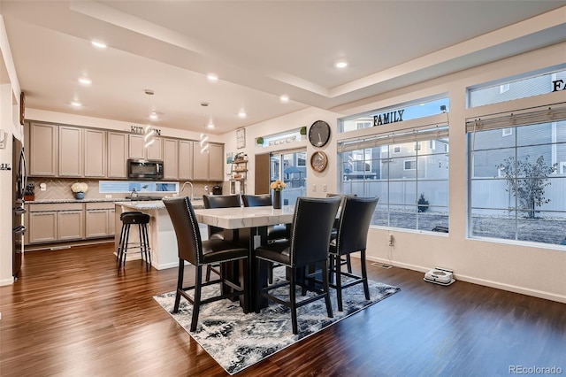 dining area with dark wood-style floors, plenty of natural light, recessed lighting, and baseboards