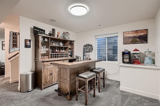 bar featuring a dry bar, visible vents, baseboards, and carpet floors