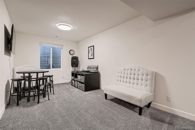 living area with carpet flooring, visible vents, and baseboards