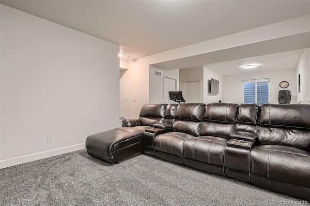 cinema room with visible vents, baseboards, and carpet