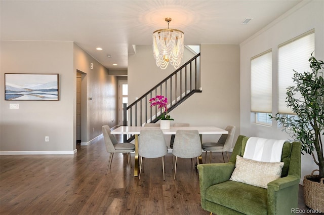 dining area featuring a notable chandelier, dark hardwood / wood-style flooring, and crown molding