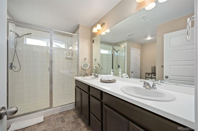 bathroom featuring vanity and a shower with shower door