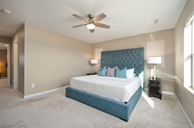 bedroom featuring ceiling fan and light carpet