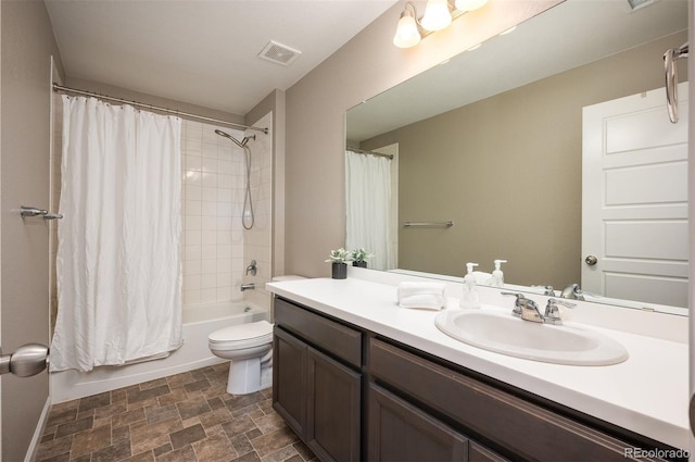 full bathroom with vanity, shower / tub combo, and toilet