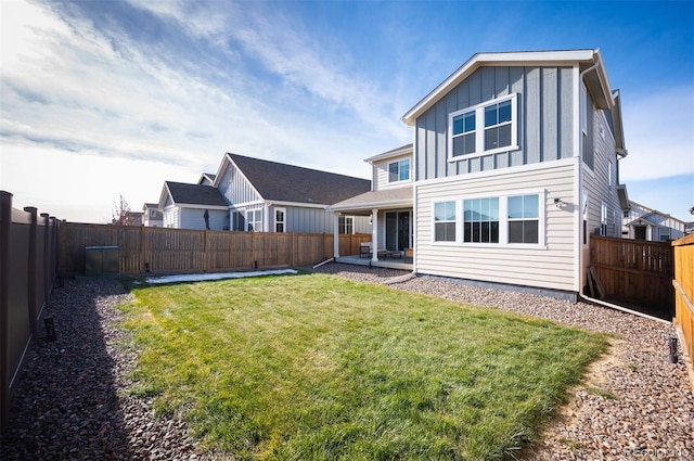 back of property featuring a lawn and a patio area