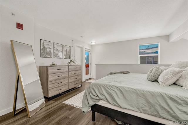 bedroom with dark hardwood / wood-style floors