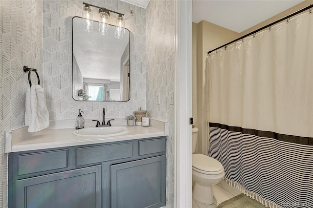 970 S Dawson Way Unit 10, Aurora, CO 80012 - bathroom with toilet, vanity, wallpapered walls, and tile patterned floors
