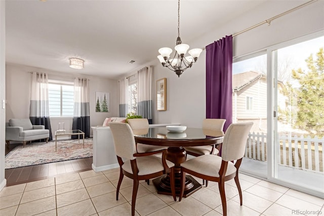 dining room featuring a chandelier, visible vents, and light tile patterned floors