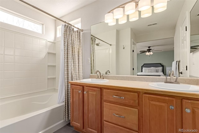 ensuite bathroom with double vanity, ensuite bath, and a sink