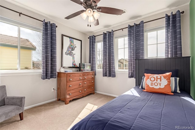 carpeted bedroom with baseboards and a ceiling fan