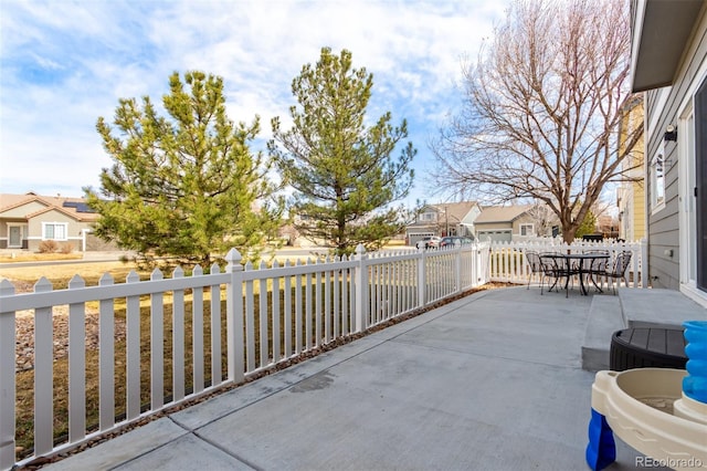 view of patio / terrace with fence private yard, a residential view, and outdoor dining area