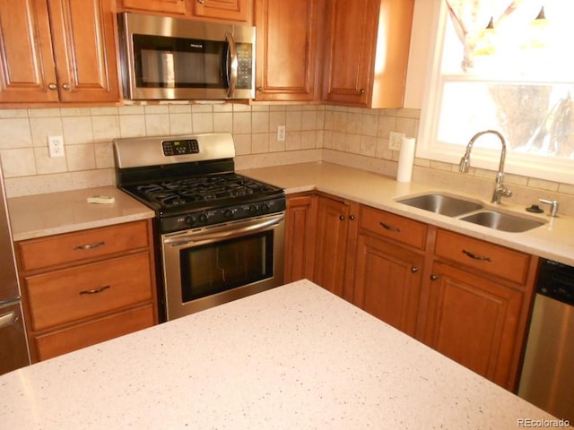 kitchen with decorative backsplash, sink, and appliances with stainless steel finishes