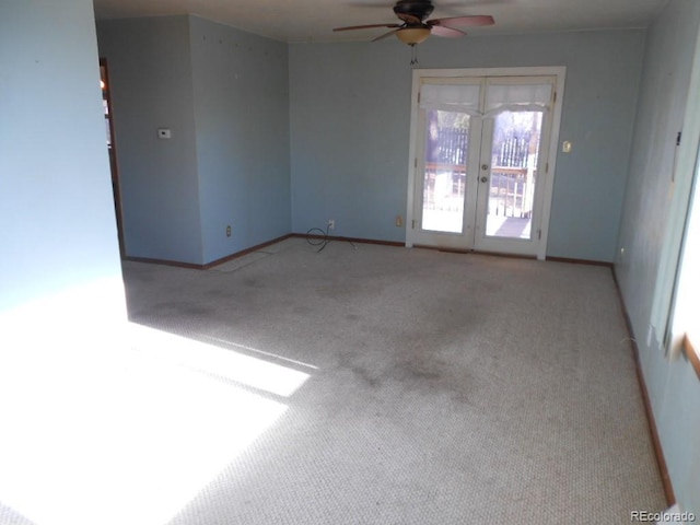 carpeted empty room with french doors and ceiling fan