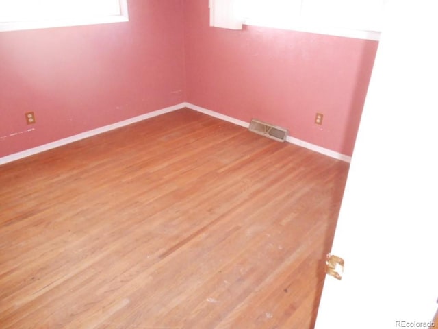 empty room with hardwood / wood-style floors