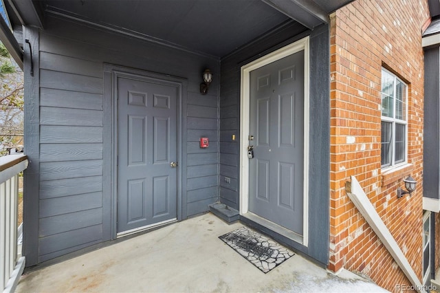property entrance featuring brick siding
