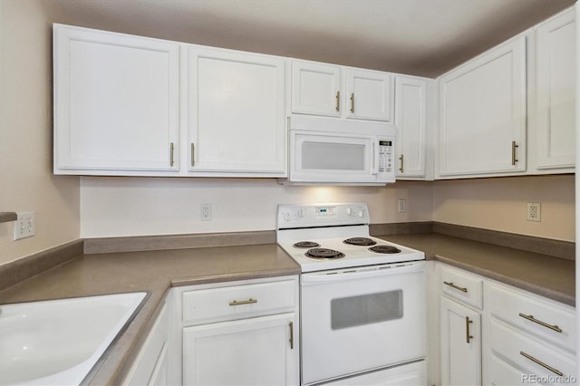 kitchen with a sink, white cabinets, and white appliances