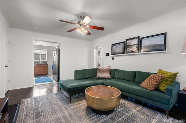 living room featuring sink, dark hardwood / wood-style flooring, and ceiling fan