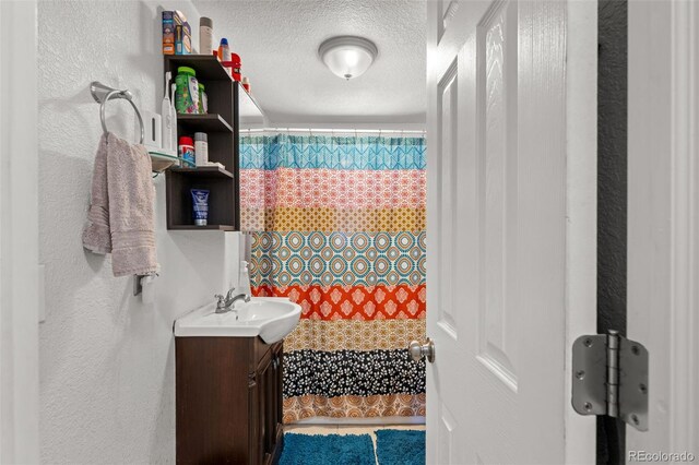 bathroom featuring vanity and a textured ceiling