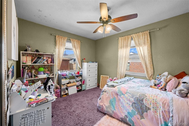 carpeted bedroom featuring ceiling fan and a textured ceiling