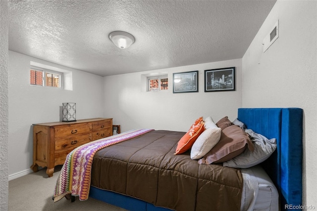 carpeted bedroom with a textured ceiling