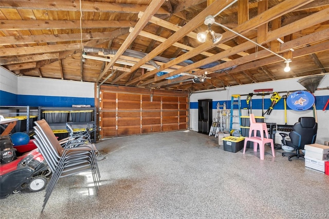 garage with a garage door opener and wooden ceiling