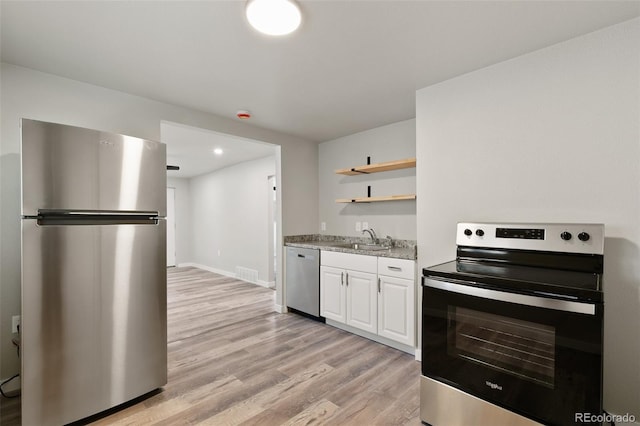 229-231 Crestone Ave, Colorado Springs, CO 80905 - kitchen with appliances with stainless steel finishes, light wood finished floors, open shelves, white cabinets, and recessed lighting