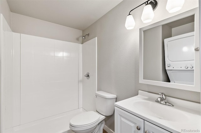 229-231 Crestone Ave, Colorado Springs, CO 80905 - full bath with stacked washing machine and dryer, vanity, a tile shower, and a textured wall