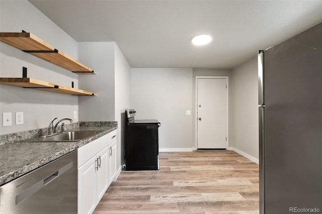 229-231 Crestone Ave, Colorado Springs, CO 80905 - kitchen with stainless steel appliances, light wood-style floors, open shelves, and white cabinetry